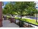 Attractive street view with lush trees and well-maintained sidewalks from a brick-lined porch at 2 S Monroe St, Denver, CO 80209