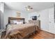 This bedroom features hardwood floors, a large bed, and a modern ceiling fan at 1165 N Pennsylvania St # G2, Denver, CO 80203
