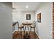 Cozy dining nook with wrought iron chairs, decorative artwork, and a bar area, perfect for entertaining at 1165 N Pennsylvania St # G2, Denver, CO 80203