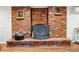 Classic brick fireplace with a black iron screen, perfect for cozy evenings, with wood storage nearby at 1165 N Pennsylvania St # G2, Denver, CO 80203