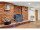 Charming brick fireplace with a decorative screen, complemented by hardwood floors and classic accents at 1165 N Pennsylvania St # G2, Denver, CO 80203