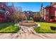 Beautifully landscaped front yard featuring a fountain and lush greenery, creating a welcoming entrance at 1165 N Pennsylvania St # G2, Denver, CO 80203