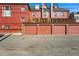 Row of garages with red doors provides convenient parking at 1165 N Pennsylvania St # G2, Denver, CO 80203