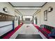 Elegant hallway with grand stairway and red carpeted floor at 1165 N Pennsylvania St # G2, Denver, CO 80203