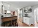 Stylish kitchen with stainless steel appliances, white cabinets, and an eat-in bar, ideal for modern living at 1165 N Pennsylvania St # G2, Denver, CO 80203