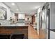 Modern kitchen with stainless steel appliances, white cabinets, and a view into the dining and living areas at 1165 N Pennsylvania St # G2, Denver, CO 80203