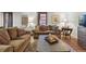 Inviting living room with a plush brown sofa, area rug, and hardwood floors, filled with natural light at 1165 N Pennsylvania St # G2, Denver, CO 80203