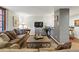 Comfortable living room featuring a plush sofa, accent pillows, and a view of the kitchen bar at 1165 N Pennsylvania St # G2, Denver, CO 80203