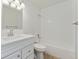 Bright bathroom with white subway tiles, modern vanity, and tub-shower combination at 4850 E Kentucky Ave # C, Denver, CO 80246