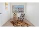 Bedroom featuring plush carpet, large window with blinds, and a stylish accent chair at 4850 E Kentucky Ave # C, Denver, CO 80246