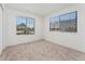 Bright, empty bedroom with plush carpet and a large window at 4850 E Kentucky Ave # C, Denver, CO 80246