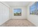 Empty bedroom with plush carpet and large windows at 4850 E Kentucky Ave # C, Denver, CO 80246