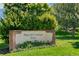 Playa del Carmen Park sign surrounded by lush greenery and vibrant flowers at 4850 E Kentucky Ave # C, Denver, CO 80246
