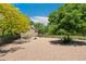 Gravel dog park with mature trees and benches at 4850 E Kentucky Ave # C, Denver, CO 80246