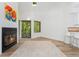 Bright living room features a cozy fireplace, skylight, and slider to balcony at 4850 E Kentucky Ave # C, Denver, CO 80246