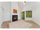 Bright living room features a cozy fireplace, skylight, and door to entry at 4850 E Kentucky Ave # C, Denver, CO 80246