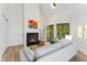 Bright living room features a cozy fireplace, skylight, and slider to balcony at 4850 E Kentucky Ave # C, Denver, CO 80246