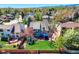 Aerial view of a spacious backyard with a lawn, patio, garden shed, swing set, and fenced perimeter at 14533 W 69Th Pl, Arvada, CO 80004