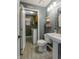 Cozy bathroom featuring a toilet, sink, and washer and dryer in a connected room at 14533 W 69Th Pl, Arvada, CO 80004