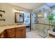 This bathroom features an expansive shower, granite counters and doorway to main bedroom at 14533 W 69Th Pl, Arvada, CO 80004