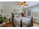 Relaxing bedroom featuring a decorative ceiling fan, natural light, and hardwood floors at 14533 W 69Th Pl, Arvada, CO 80004