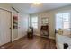 Cozy bedroom with wood floors, a writing desk and natural light from two windows at 14533 W 69Th Pl, Arvada, CO 80004