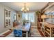 Elegant dining room featuring wood table with floral centerpiece, wood floors, and decorative accents at 14533 W 69Th Pl, Arvada, CO 80004