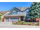 Charming two-story home with a brick and siding exterior and a well-manicured front yard at 14533 W 69Th Pl, Arvada, CO 80004