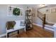 Inviting foyer with hardwood floors, a white bench, decorative shelving, and a staircase at 14533 W 69Th Pl, Arvada, CO 80004