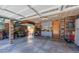 Spacious garage with ample storage, tools, wood paneled walls, and organized work areas at 14533 W 69Th Pl, Arvada, CO 80004