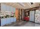 Organized garage featuring workbenches, tools, wood walls and a storage area at 14533 W 69Th Pl, Arvada, CO 80004