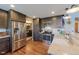 Modern kitchen with stainless steel appliances, dark wood cabinets, granite countertops, and hardwood floors at 14533 W 69Th Pl, Arvada, CO 80004