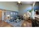 Spacious living room showcasing a large sectional sofa, hardwood floors, and contemporary decor at 14533 W 69Th Pl, Arvada, CO 80004