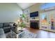 Inviting living room featuring a fireplace, french doors, hardwood floors, and comfortable seating area at 14533 W 69Th Pl, Arvada, CO 80004