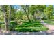 Picturesque walking path surrounded by lush greenery and trees with a stream at 14533 W 69Th Pl, Arvada, CO 80004