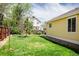 Spacious backyard with lush green grass and mature trees offering ample privacy and shade at 1606 Iris St, Broomfield, CO 80020