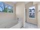 Bathroom features soaking tub, walk-in shower, and bright window at 1606 Iris St, Broomfield, CO 80020