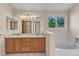 Bathroom features double sinks, bathtub, and natural light at 1606 Iris St, Broomfield, CO 80020
