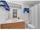 Modern bathroom with a neutral countertop, white sink, and blue cabinets at 1606 Iris St, Broomfield, CO 80020
