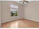 Bedroom features large window, neutral paint, and hardwood floors at 1606 Iris St, Broomfield, CO 80020