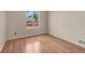 Well-lit bedroom features natural light with hardwood floors and neutral walls at 1606 Iris St, Broomfield, CO 80020
