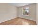 Bright bedroom featuring hardwood floors, a window with natural light, and neutral walls at 1606 Iris St, Broomfield, CO 80020