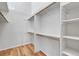 Spacious walk-in closet with shelving and hardwood floors at 1606 Iris St, Broomfield, CO 80020