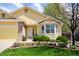 Close up of a well landscaped front yard and yellow home with bay window at 1606 Iris St, Broomfield, CO 80020