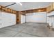 Spacious two-car garage featuring concrete flooring, insulated doors, and ample storage at 1606 Iris St, Broomfield, CO 80020