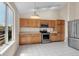 Well-lit kitchen featuring stainless steel appliances and tile flooring at 1606 Iris St, Broomfield, CO 80020