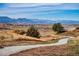 Sweeping landscape view with winding gravel path leading to distant mountains under a clear sky at 1606 Iris St, Broomfield, CO 80020