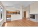 Open-concept living area with hardwood floors, fireplace, and bright kitchen at 1606 Iris St, Broomfield, CO 80020