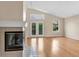 Light-filled living room with fireplace, hardwood floors, and backyard access at 1606 Iris St, Broomfield, CO 80020