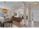 Bright, open-concept living room and dining area with hardwood floors and decorative lighting fixture at 1606 Iris St, Broomfield, CO 80020